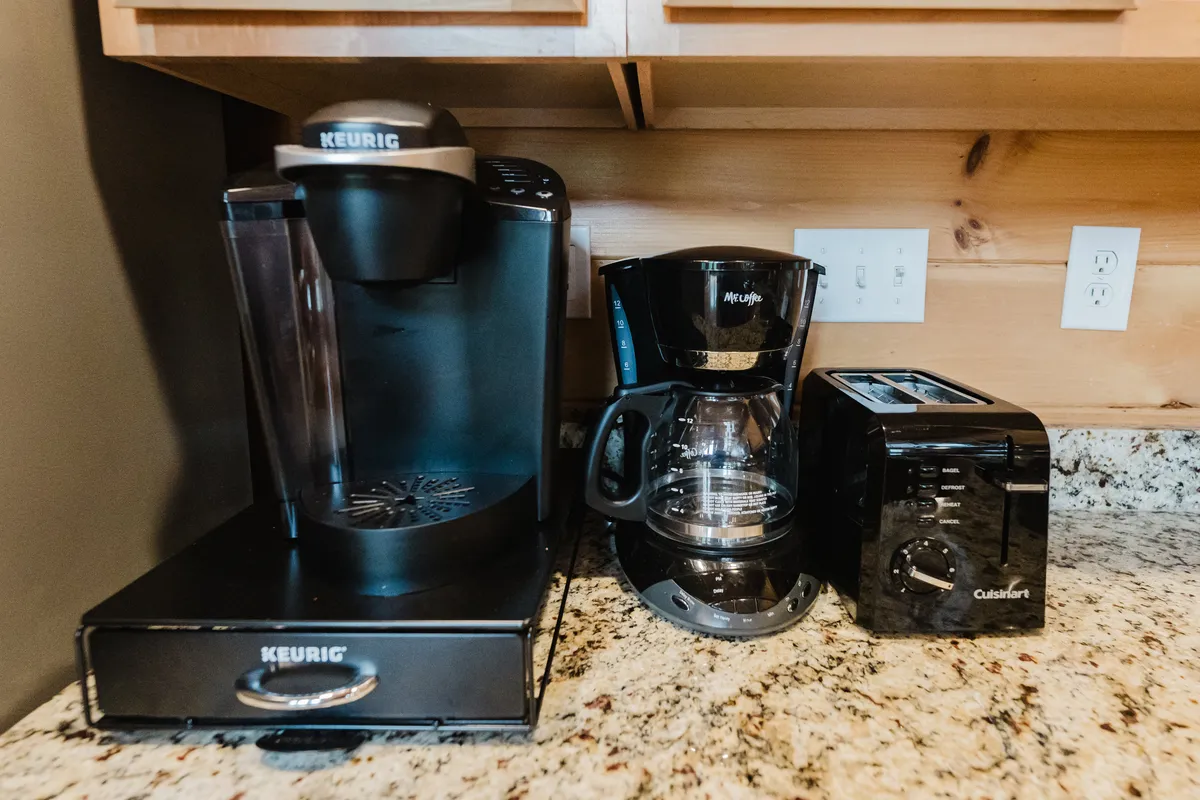 A close-up of the kitchen’s beverage station, featuring a Keurig, drip coffee maker, and toaster. The setup is tidy and inviting, suggesting an easy, enjoyable morning routine for guests.